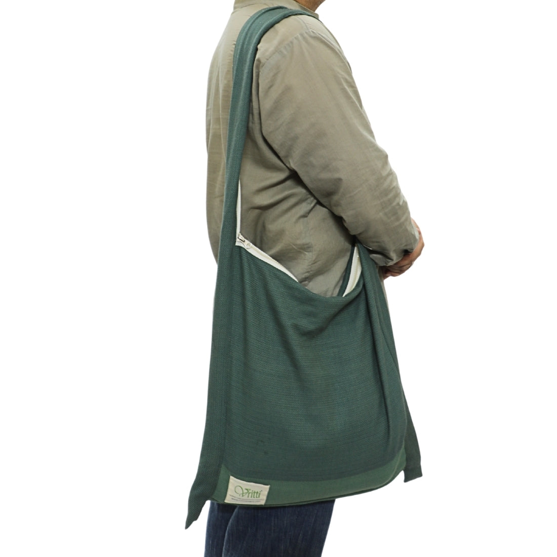 Person wearing a green jhola bag as one side shoulder bag