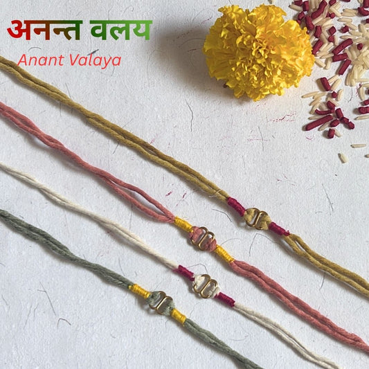 Organic Cotton Rakhi handcrafted with naturally dyed organic cotton threads and an infinity brass connector. Includes cotton potli, Tilak, Akshat and handmade recycled cotton rag envelope.