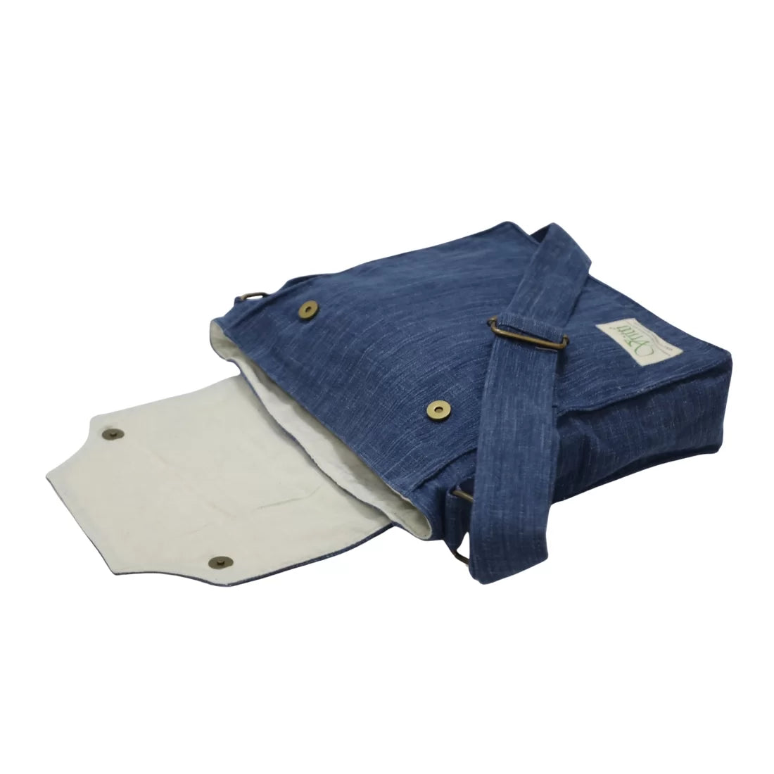 Handmade handloom denim crossbody bag in natural indigo dyed yarn. Brass snap closure, adjustable strap, zipped interior pocket. 14x14 inches. Made in India.