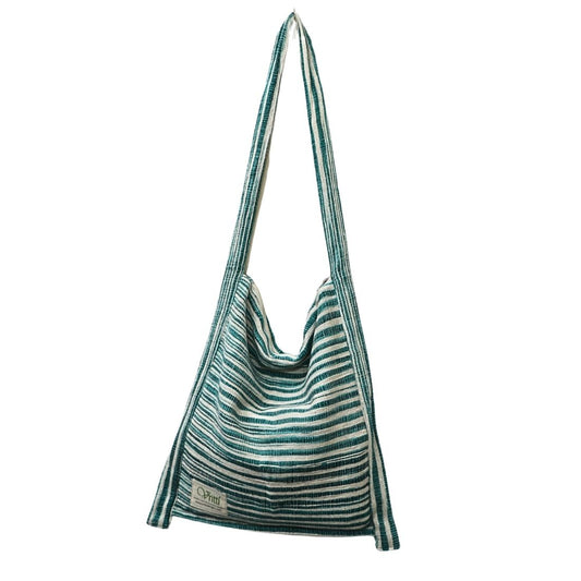 This green stripe bag is crafted from traditional handloom cotton, offering a balance of durability and everyday ease. Designed for practical use with an understated artisanal appeal. 