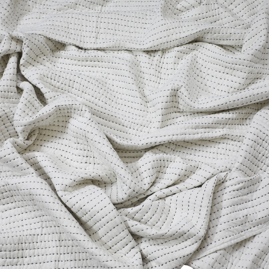 white kantha quilt with grey stitching cotton quilt texture
