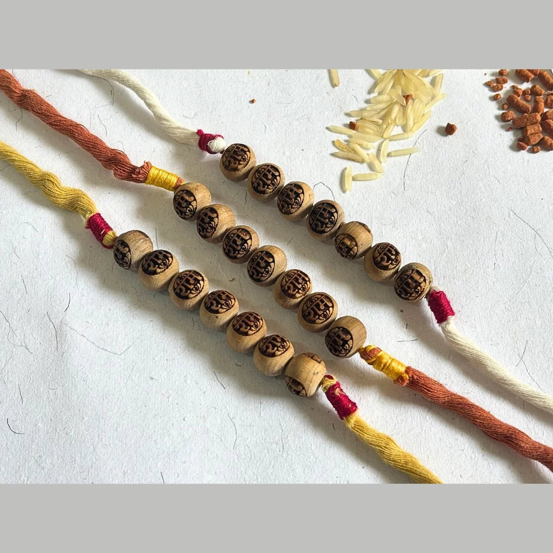 Tulsi bead rakhi Ram carved mustard yellow natural dyed organic cotton eco friendly handmade