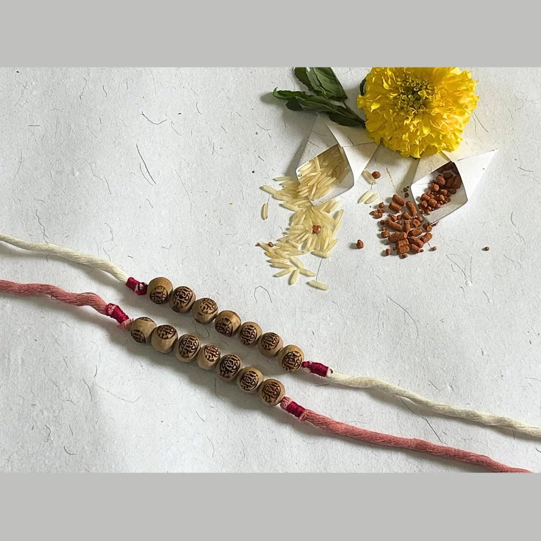 Radha carved Tulsi bead rakhi dusty rose pink natural dyed organic cotton eco friendly handmade