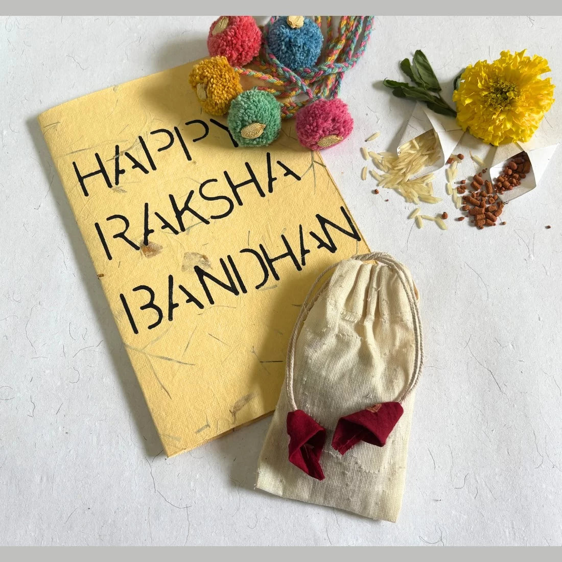 Handmade pom pom seed rakhi from recycled yarn. Available in set of 3 or 5. 5 colours. Biodegradable packaging. Made by women artisans in India.