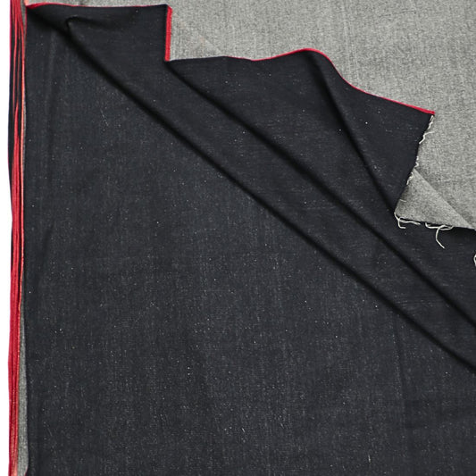 9oz hand spun, hand woven black handloom denim with red selvedge. Naturally dyed with iron rust & jaggery. Small-batch, artisan-made. 